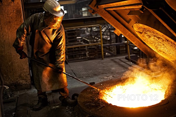 Worker on tanks with liquid iron