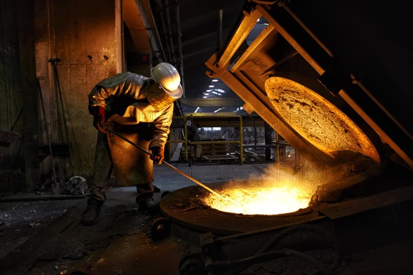 Worker on tanks with liquid iron