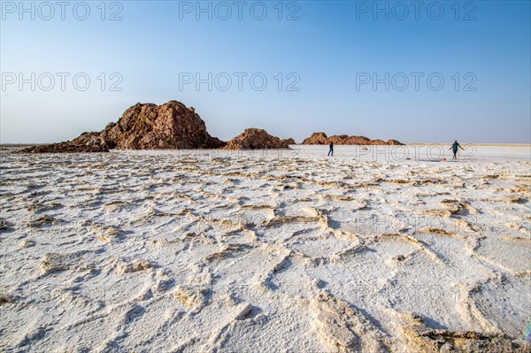 Tourists walk on salt flat