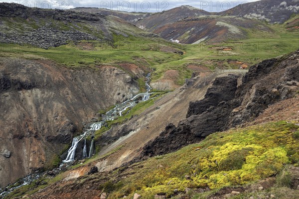 Volcanic landscape and waterfall on the hiking trail to Reykjadalur