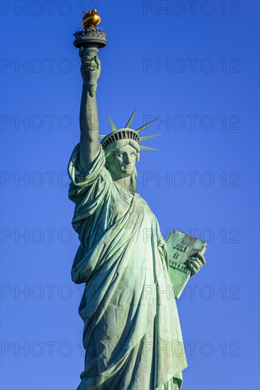 Statue of Liberty in front of blue sky