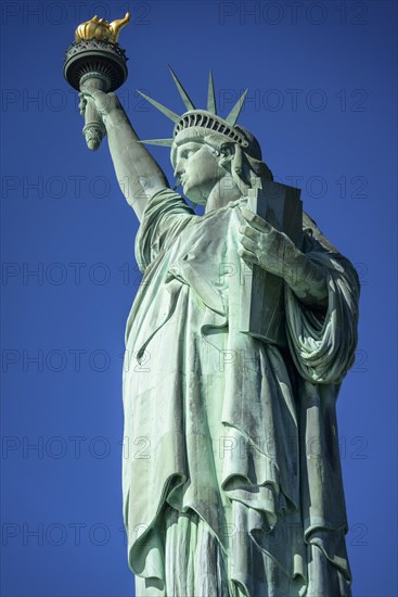 Statue of Liberty in front of blue sky
