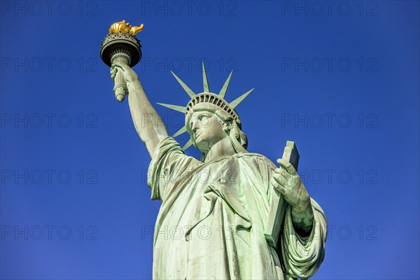 Statue of Liberty in front of blue sky