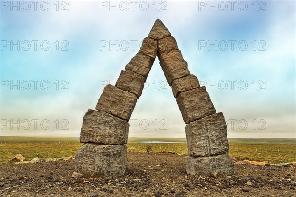 Monumental stone gate in barren landscape