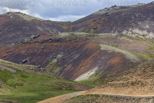 Barren volcanic landscape on the hiking trail to Reykjadalur