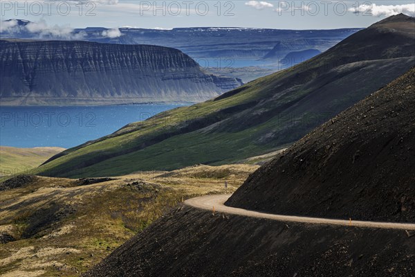 Gravel road meanders through volcanic landscape