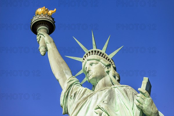 Statue of Liberty in front of blue sky