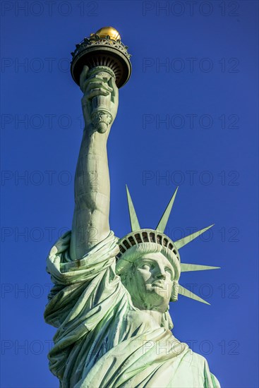 Statue of Liberty in front of blue sky