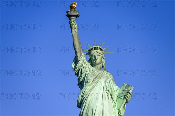 Statue of Liberty in front of blue sky