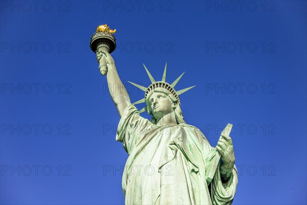 Statue of Liberty in front of blue sky