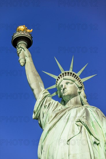 Statue of Liberty in front of blue sky