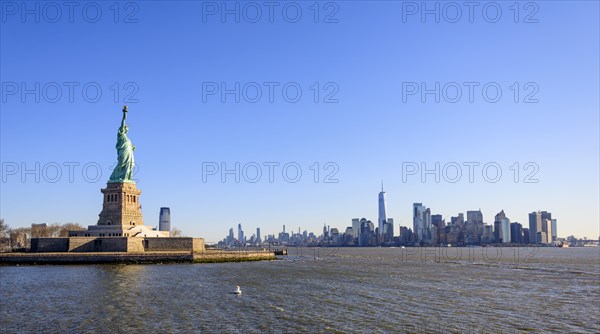 Statue of Liberty in front of Manhattan skyline