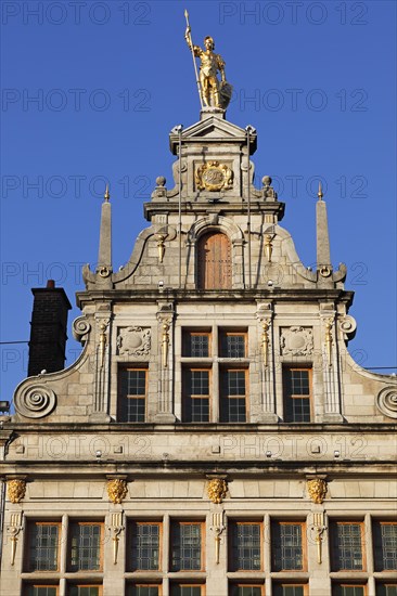 Golden figure on the gable of a guild house