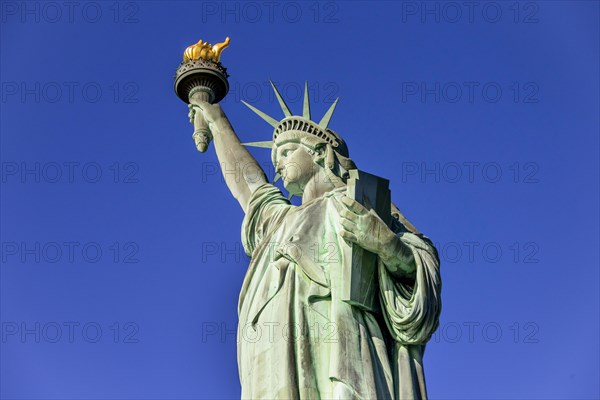 Statue of Liberty in front of blue sky