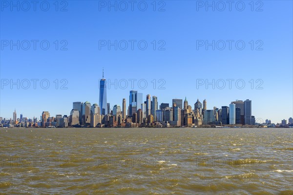 View from Ellis Island to the skyline of Lower Manhattan with skyscrapers