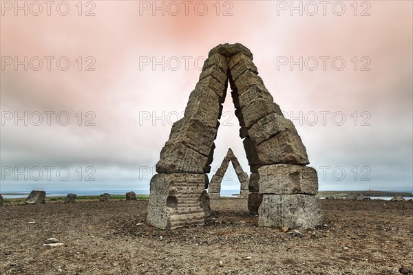 Monumental stone gates in barren landscape