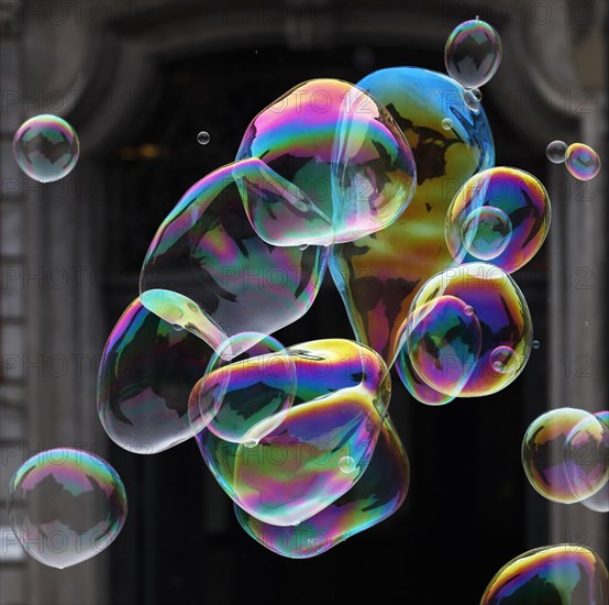 Large soap bubbles fly through the air