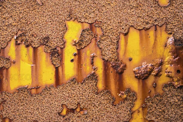 Rust on yellow metal wall