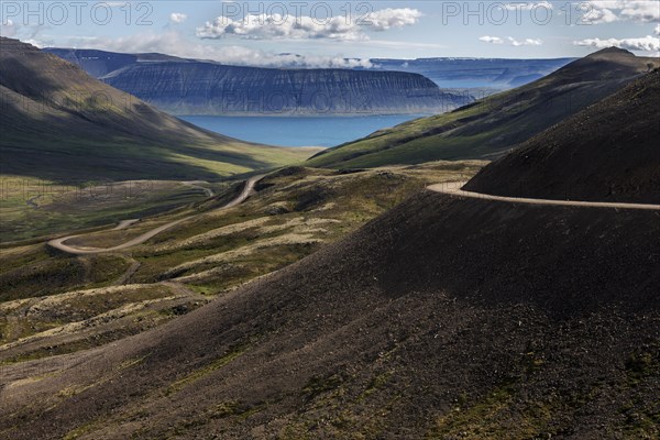 Gravel road meanders through volcanic landscape