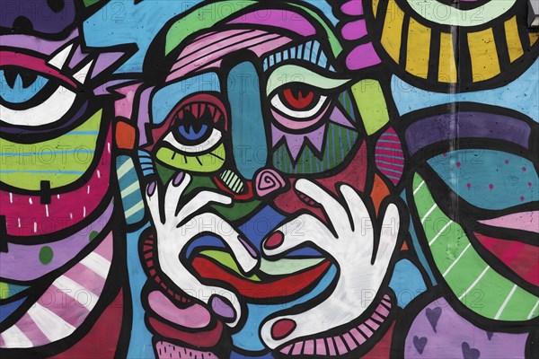 Colourful face with hand signal heart
