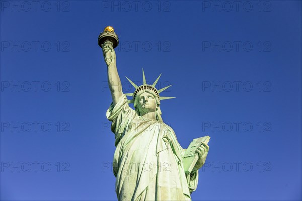 Statue of Liberty in front of blue sky