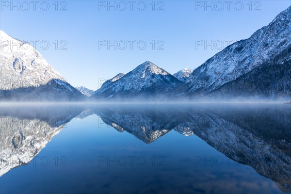 Fog over mountain lake