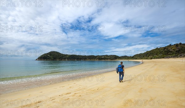 Young man walks on the beach