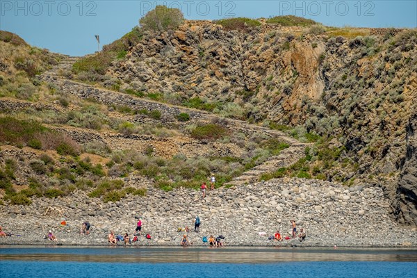 Tourists on the rocky beach