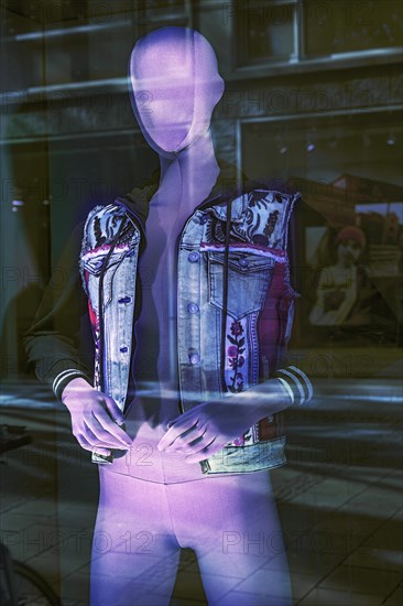 Fashion doll with jeans jacket in shop window