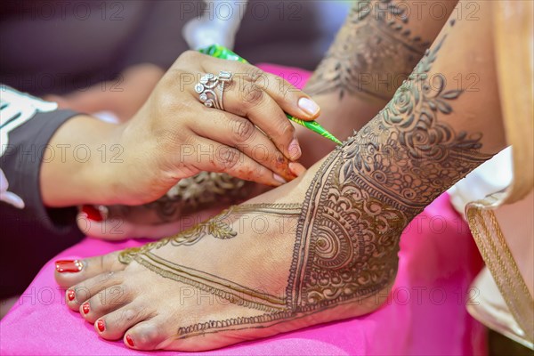 Close up of mehendi on foot of a bride