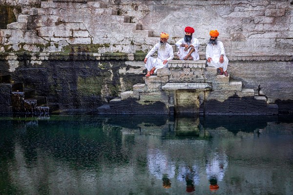 Three men resting at the stepwell Toorji Ka Jhalra in Jodhpur