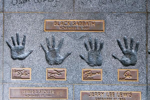 Hands of the band Black Sabbath with Geezer ButlerTony Iommi