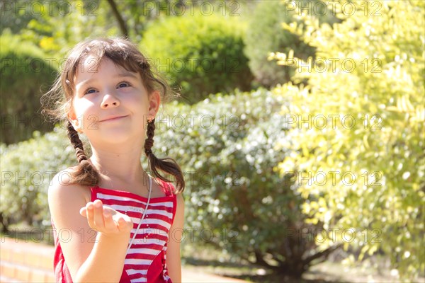 Little girl sends an air kiss and smiling