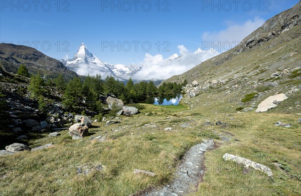 Hiking trail with view of Lake Grindij and snow-covered Matterhorn