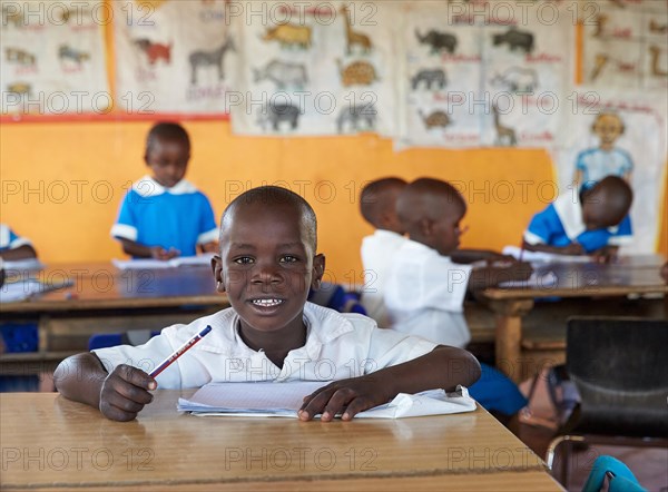 Students at the school desk in the preschool in the classroom