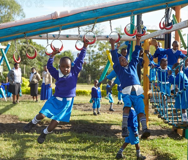 Schoolgirls playing on the climbing frame in the schoolyard