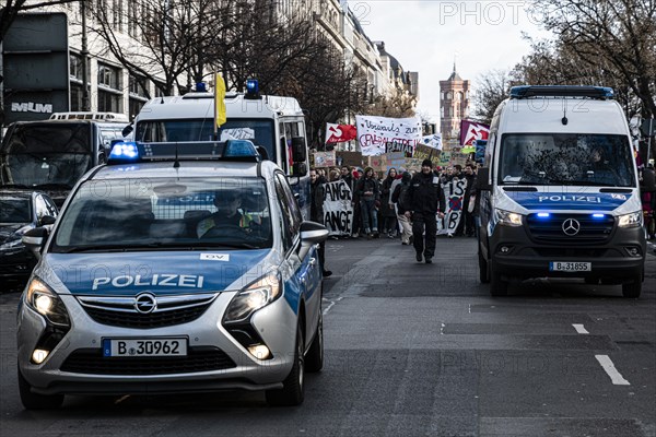 Police cars at the edge of the demonstration