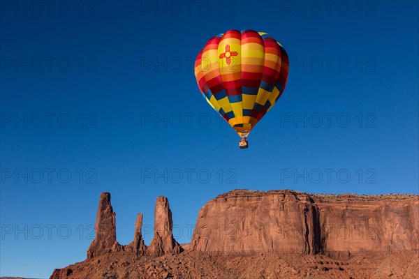 Hot air balloon flies in front of the Three Sisters