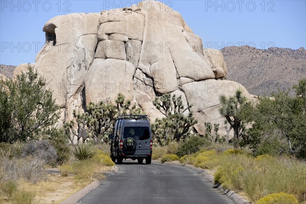 Camper on a road in front of Rock
