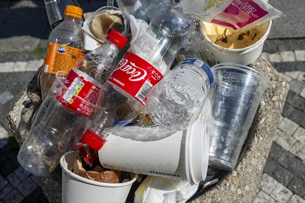 Full rubbish bin with lots of plastic waste and empty plastic bottles