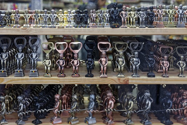 Small Manneken Pis figures as bottle openers and corkscrews in display in shop window