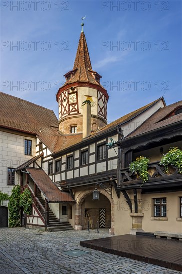 Gothic half-timbered tower and gate to the castle courtyard
