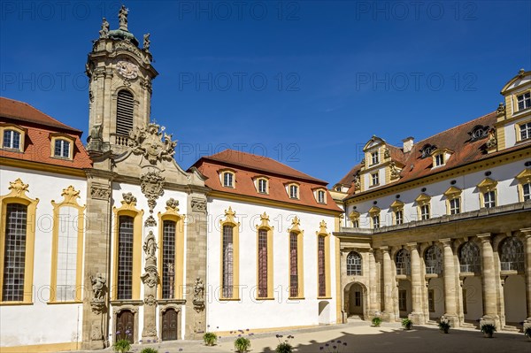 Castle courtyard with baroque castle church and colonnades