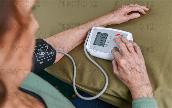 Old woman measuring blood pressure