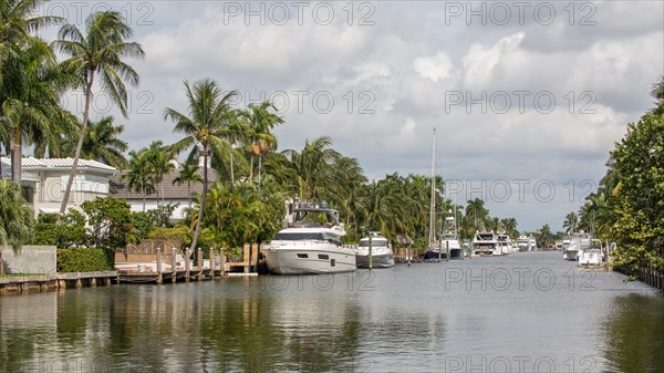 Canal with luxury yachts in front of residential buildings