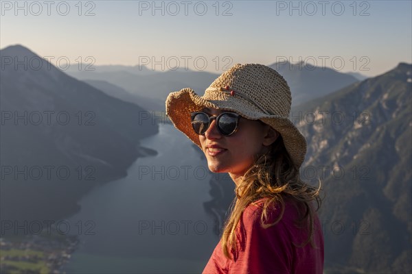 Young woman with sunglasses and sun hat