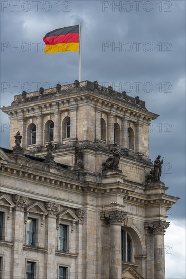 Reichstag with waving German flag at the Spree