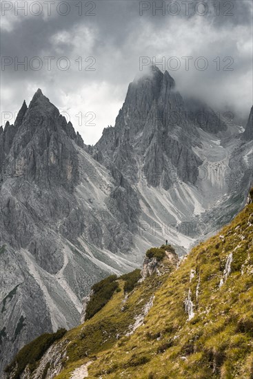 Mountaineer stands on a ridge