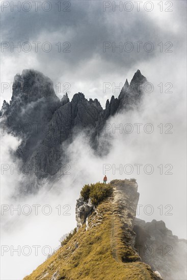 Mountaineer stands on a ridge