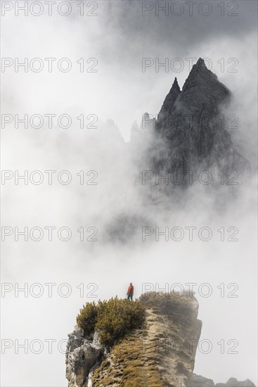 Mountaineer stands on a ridge